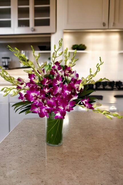 Mother’s Day purple orchid arrangement in a modern glass vase on a kitchen countertop