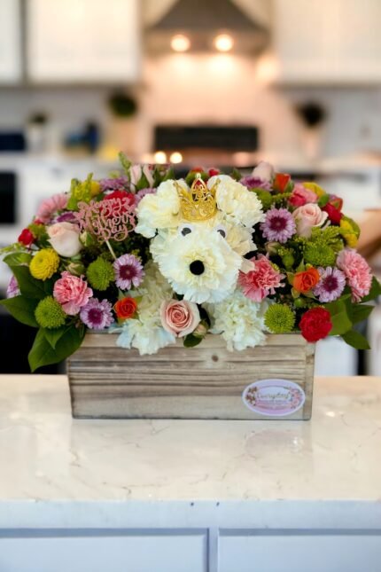 Mother’s Day flower dog arrangement with crown and colorful flowers in a wooden box on a kitchen countertop