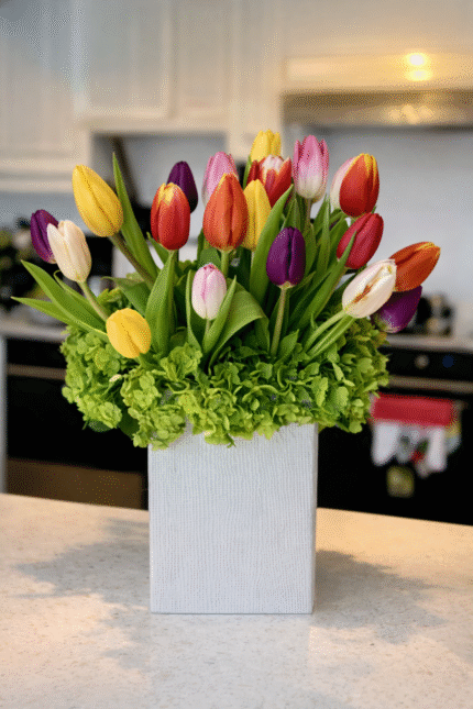 Mother’s Day tulip arrangement with colorful tulips in a modern square vase on a kitchen countertop