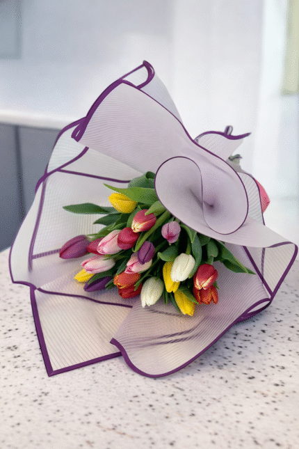Mother’s Day tulip bouquet wrapped in elegant paper with mixed color tulips on a modern kitchen countertop