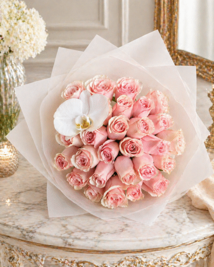 Mother’s Day bouquet with blush pink roses and white orchid on elegant marble table